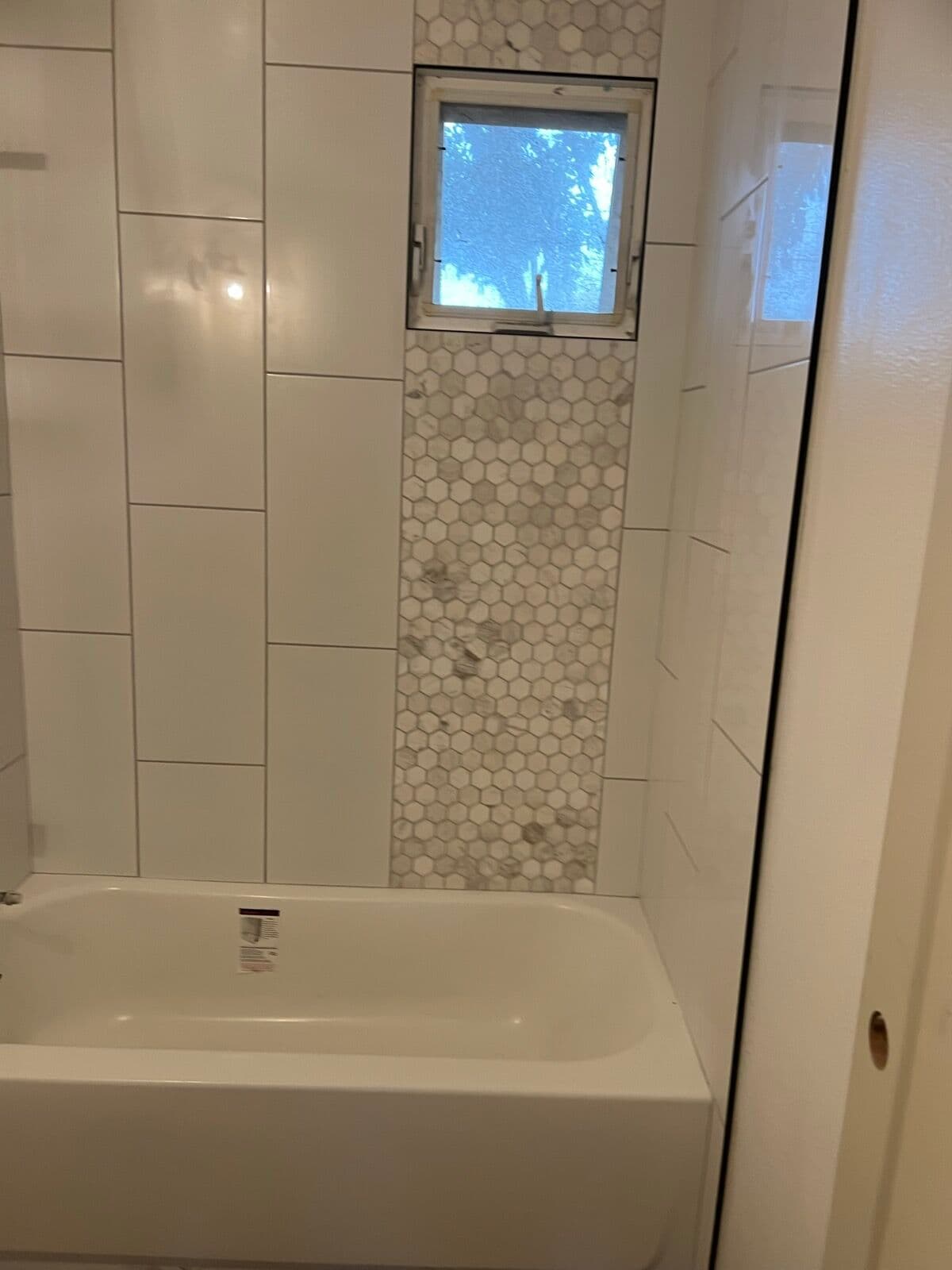 After — Shower accent wall: tile going up to finished
