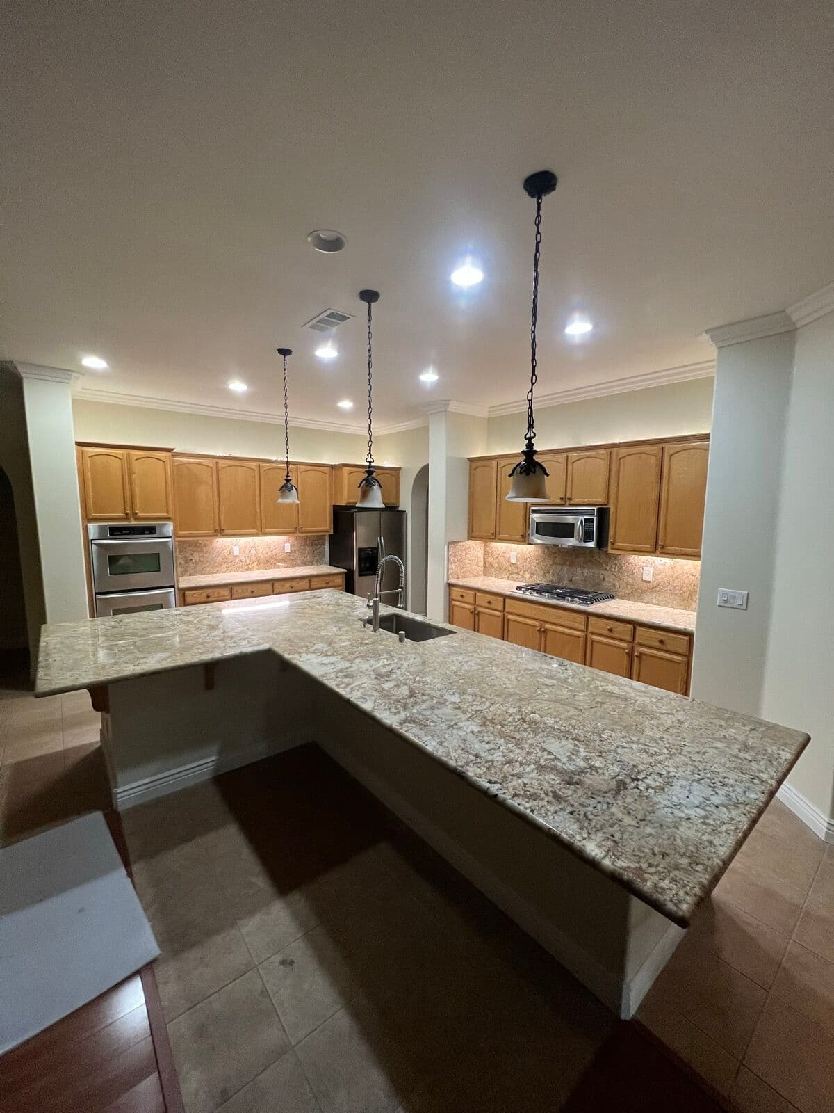 After — Island and counters: tile to slab granite
