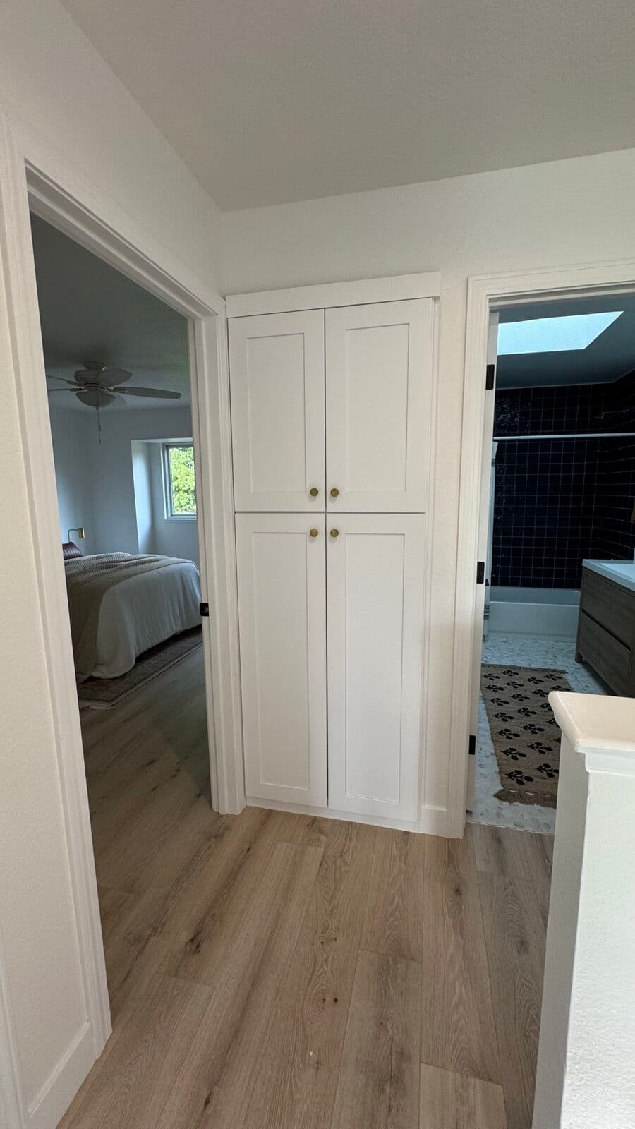 Hallway built-ins with white shaker cabinet doors and finished trim