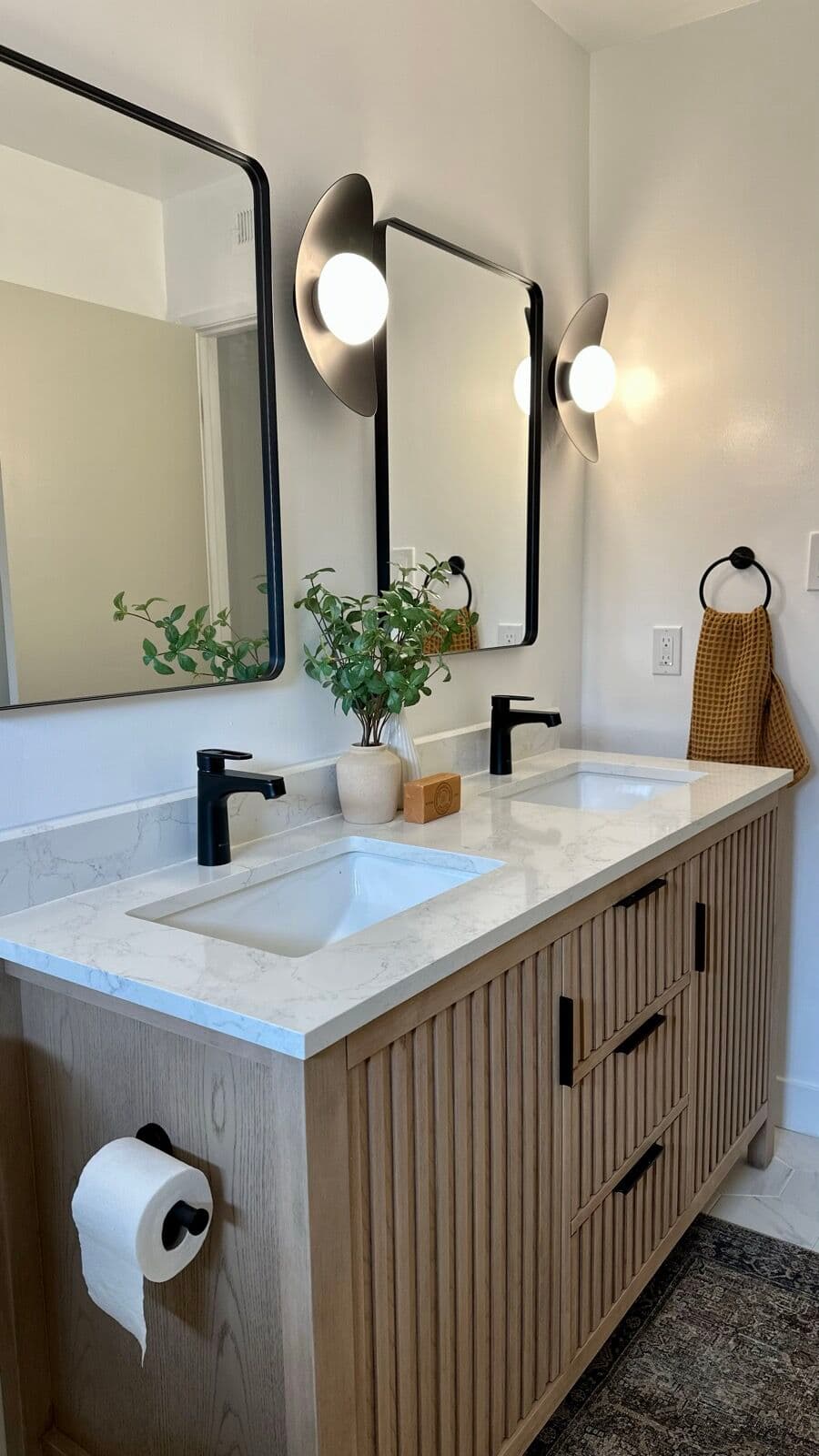 Fluted white-oak double vanity with quartz top and matte black fixtures